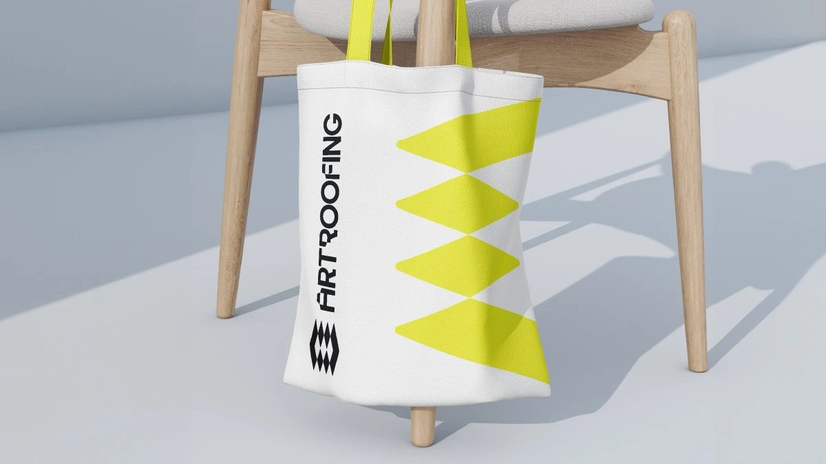 Art Roofing tote bag with yellow diamond pattern hanging on a chair