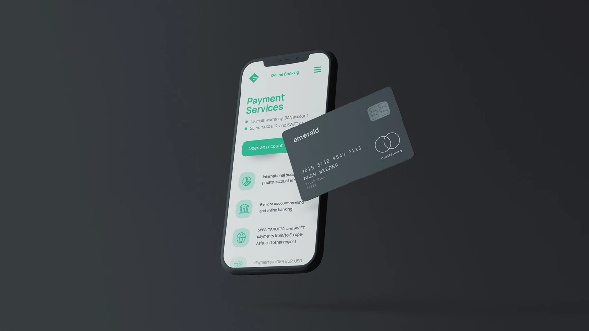 Emerald banking app on a phone beside a dark payment card mockup