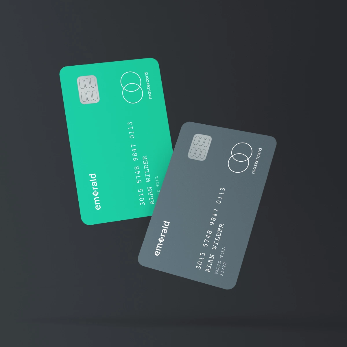 Emerald Bank cards in green and grey, angled against dark background