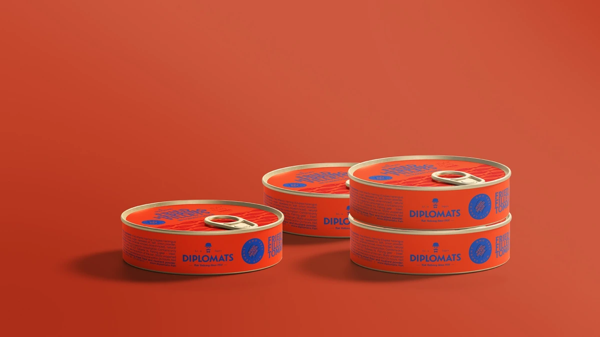 Four orange Fried Herring Fillets tins on red background
