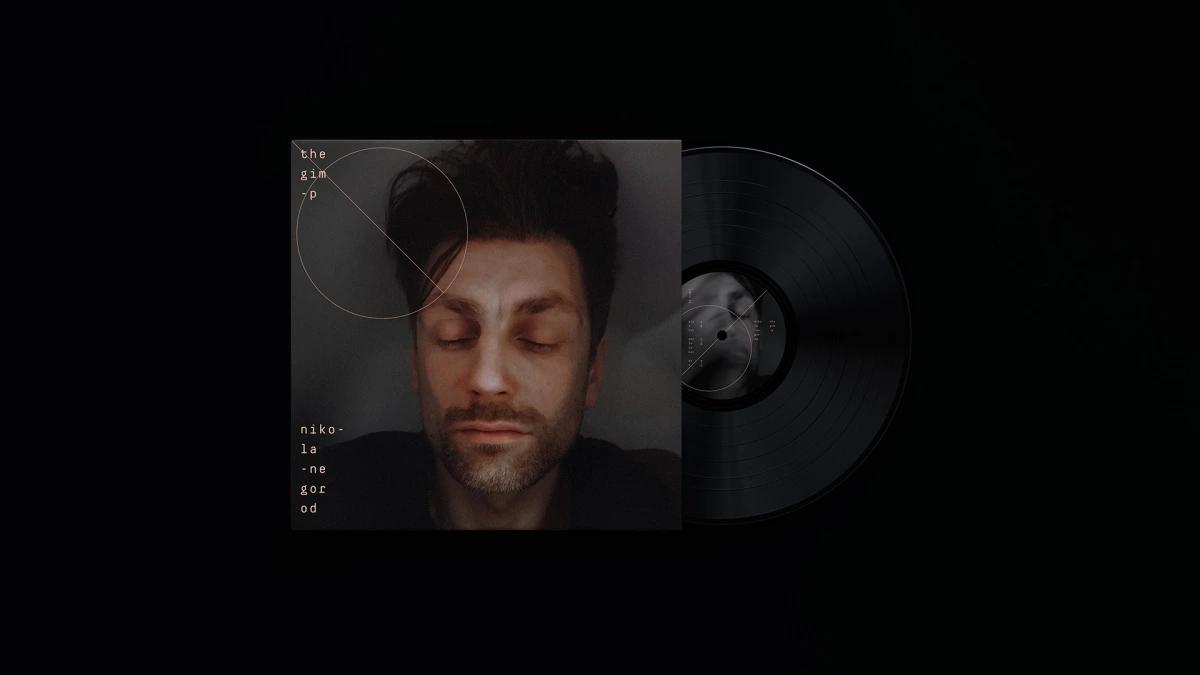 The Gimp vinyl sleeve leaning against black record on dark background