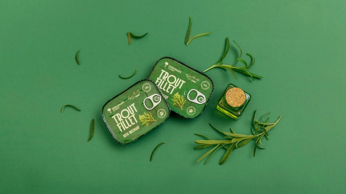 Trout Fillet rosemary tins from above, oil bottle and scattered rosemary needles