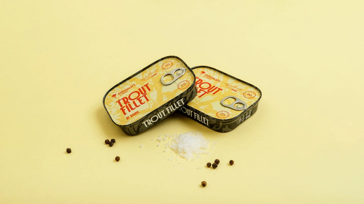 Trout Fillet brine tins leaning together, pepper and salt scattered below
